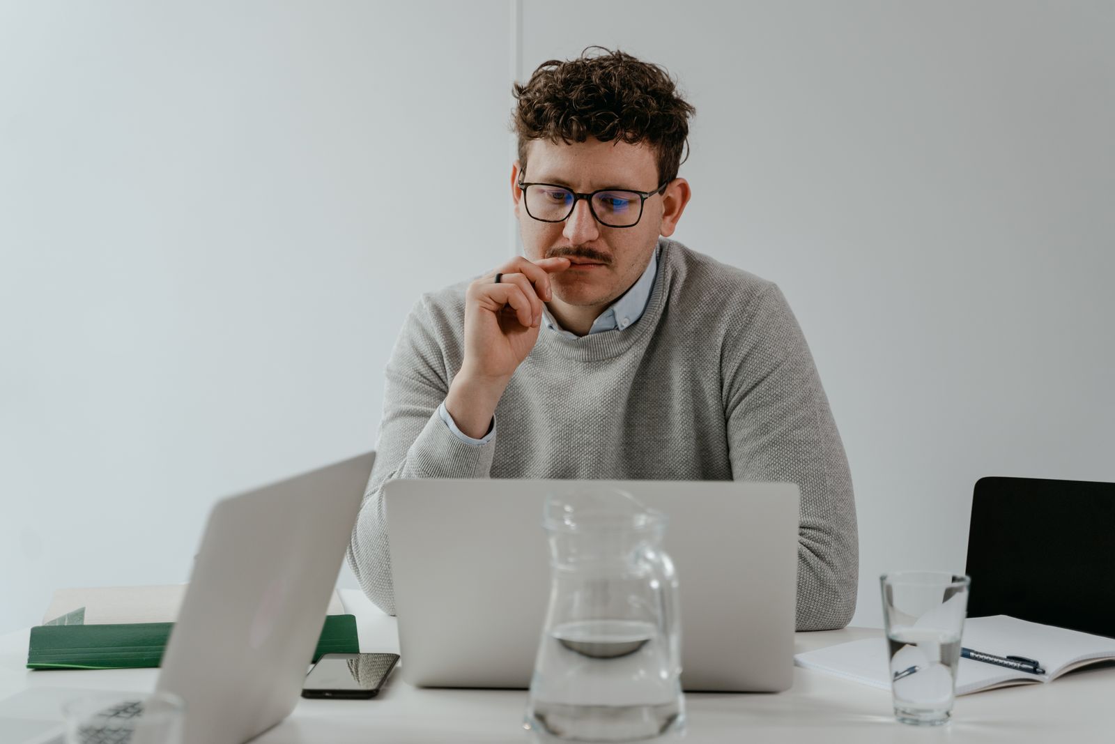 Professional researching UAE business setup FAQs on a laptop