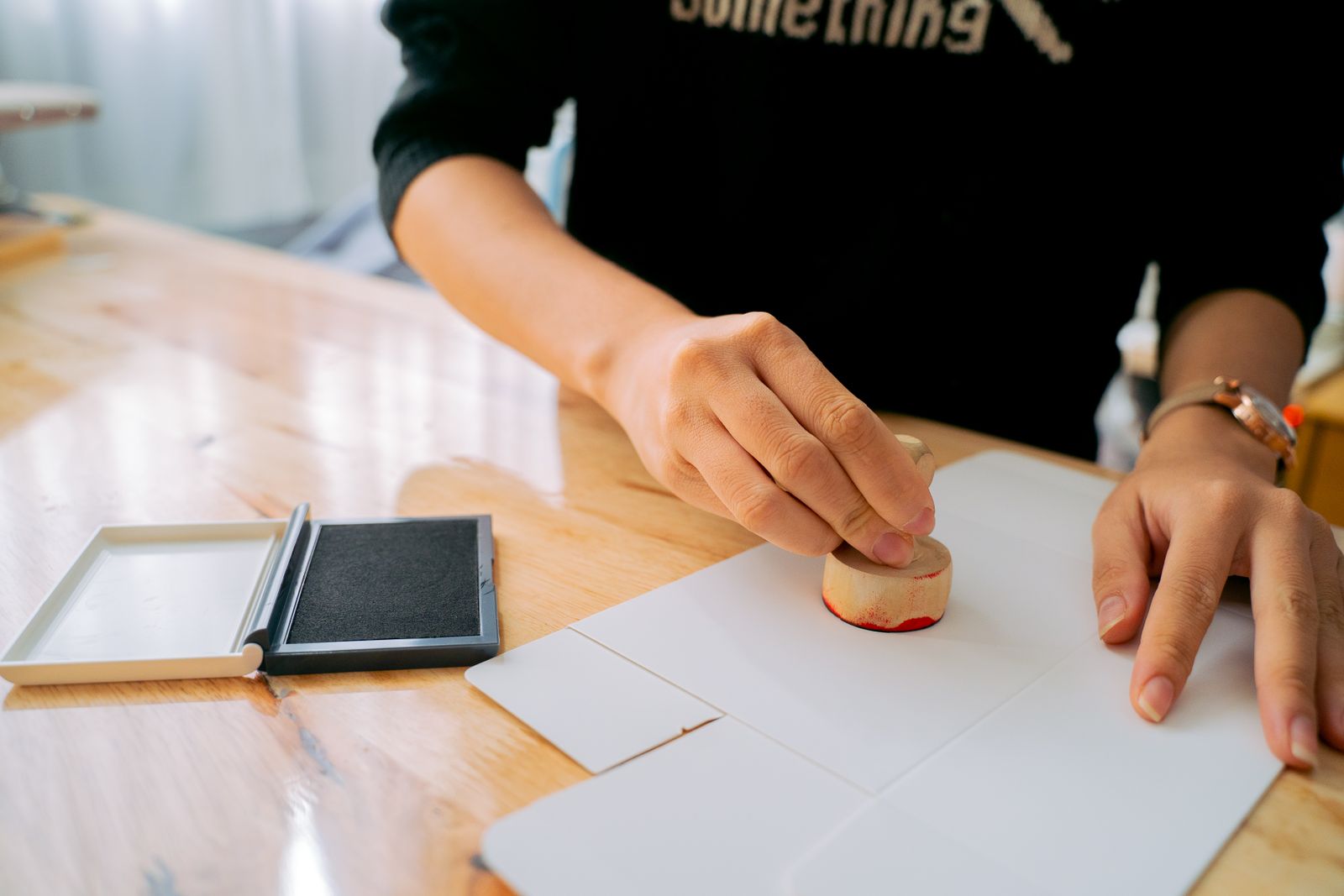 Hands stamping an official UAE government document for PRO services